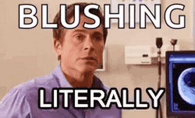 A Man In A Purple Shirt Is Sitting In Front Of A Computer Screen With The Words Blushing Literally . GIF