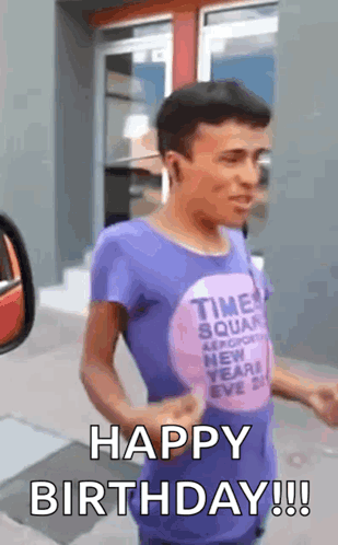 A Man In A Purple Shirt Is Standing In Front Of A Building And Says `` Happy Birthday '' . GIF