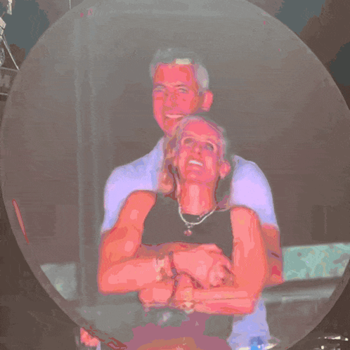A Man In A Purple Shirt Is Standing Next To A Woman In A Pink Shirt GIF