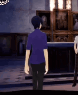 A Man In A Purple Shirt Is Standing Next To A Woman In A White Shirt In A Room . GIF