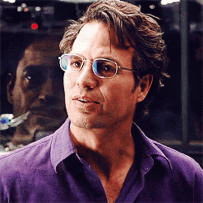 A Man In A Purple Shirt Is Wearing Glasses GIF