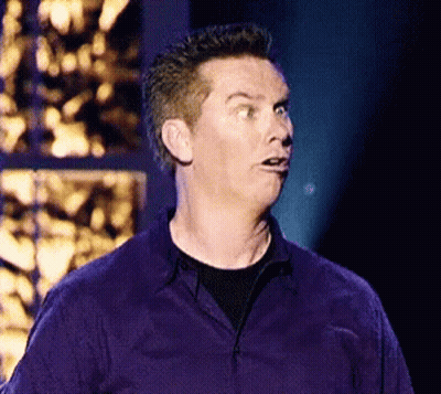 A Man In A Purple Shirt Making A Funny Face GIF