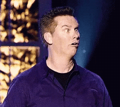 A Man In A Purple Shirt Making A Surprised Face GIF