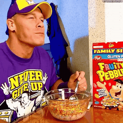 A Man In A Purple Shirt That Says Never Give Up Is Eating Fruity Pebbles GIF