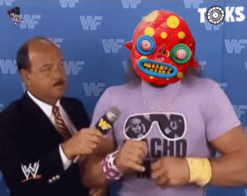A Man In A Purple Shirt With The Word Choo On It Is Talking Into A Microphone GIF