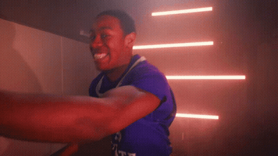 A Man In A Purple Shirt With The Word Duke On The Front GIF