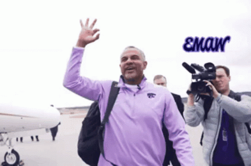 A Man In A Purple Shirt With The Word Emaw On The Bottom Right GIF