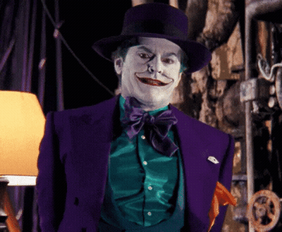 A Man In A Purple Suit And Top Hat Is Making A Funny Face GIF