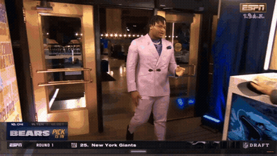 A Man In A Purple Suit Is Standing In Front Of A Door That Says Espn GIF
