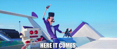 A Man In A Purple Suit Is Standing Next To A Robot And The Words Here It Comes GIF