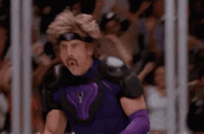 A Man In A Purple Superhero Costume Is Standing In Front Of A Crowd . GIF