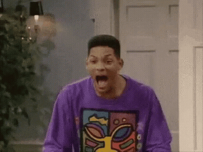 A Man In A Purple Sweater Is Screaming In A Room . GIF