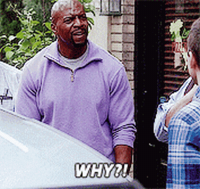A Man In A Purple Sweater Is Talking To A Man In A Plaid Shirt GIF