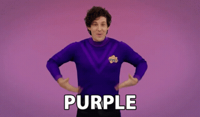 A Man In A Purple Sweater Says Purple GIF