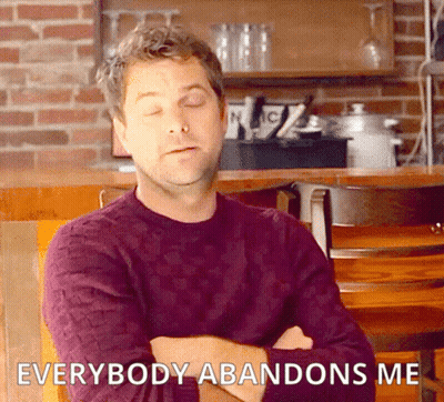 A Man In A Purple Sweater Sits In A Chair With His Arms Crossed And Says Everybody Abandons Me . GIF