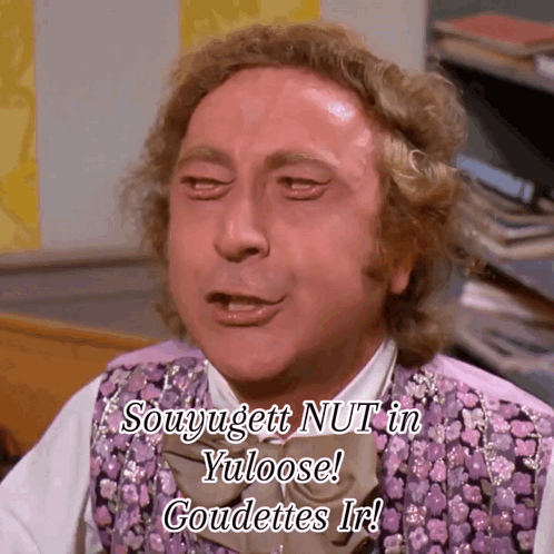 A Man In A Purple Vest And Bow Tie Says Souyugett Nut In Yuloose Goudettes Ir GIF