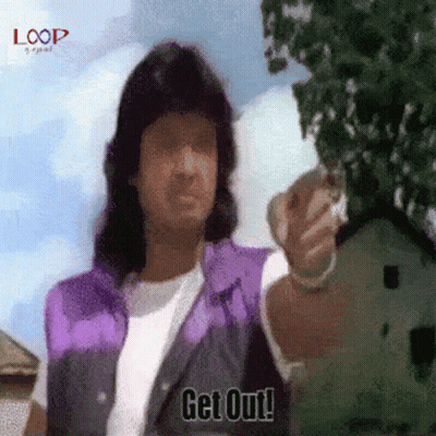 A Man In A Purple Vest Says " Get Out " While Pointing At Something GIF