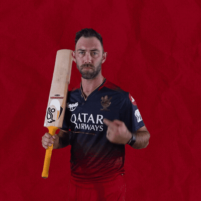 A Man In A Qatar Airways Shirt Is Holding A Cricket Bat GIF