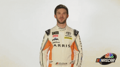 A Man In A Race Car Uniform Is Saying Wow . GIF