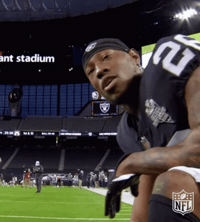 A Man In A Raiders Jersey Stands On A Football Field GIF