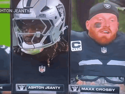 A Man In A Raiders Uniform Stands Next To A Man In A Helmet GIF