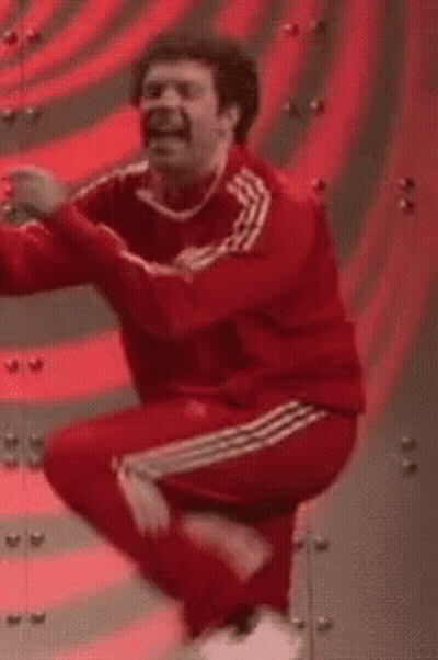 A Man In A Red Adidas Tracksuit Is Dancing . GIF