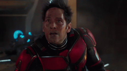 a man in a red and black armor looks up