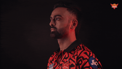 A Man In A Red And Black Shirt With Jio On His Arm GIF