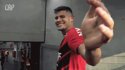 A Man In A Red And Black Shirt With The Word Cap On The Bottom GIF
