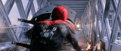 A Man In A Red And Black Spiderman Suit Is Flying Through The Air GIF