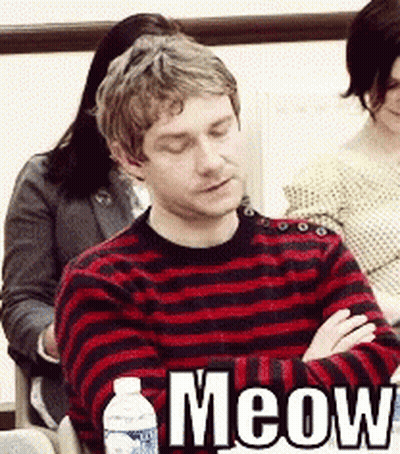 A Man In A Red And Black Striped Sweater Is Sitting With His Eyes Closed GIF
