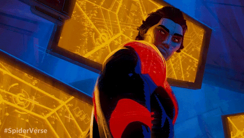 A Man In A Red And Black Suit Is Standing In Front Of A Screen That Says Spiderverse On It GIF
