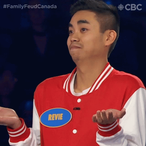 A Man In A Red And White Jacket Has A Name Tag That Says Revie GIF