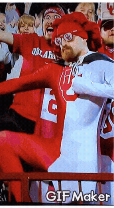 A Man In A Red And White Outfit With The Letter G On It GIF