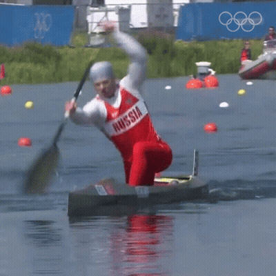 A Man In A Red And White Russia Shirt Is Paddling A Kayak GIF
