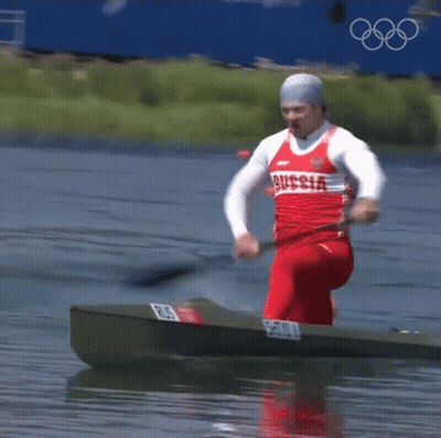 A Man In A Red And White Russia Shirt Is Rowing A Boat GIF