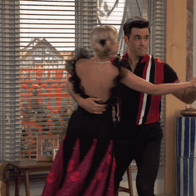 A Man In A Red And White Shirt Is Dancing With A Woman In A Black Dress GIF