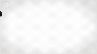 A Man In A Red And White Striped Red Bull Jersey GIF
