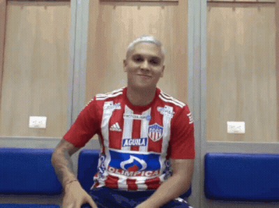 A Man In A Red And White Striped Shirt With The Word Aguila On It GIF
