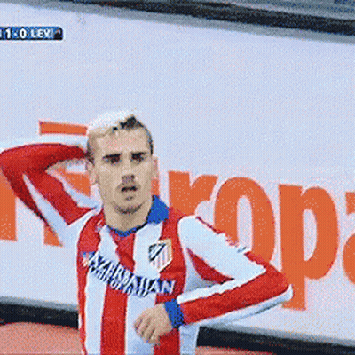 A Man In A Red And White Striped Shirt With The Word Atl On It Stands In Front Of A Sign That Says Rope GIF