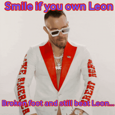 A Man In A Red And White Suit With The Caption Smile If You Own Leon GIF