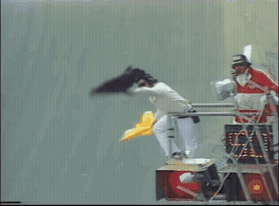 A Man In A Red And White Uniform Is Standing On A Ladder GIF