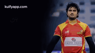 A Man In A Red And Yellow Jersey With The Word Pride India On It GIF