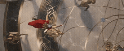 A Man In A Red Cape Is Flying Through A Circle GIF
