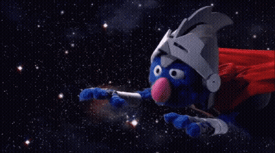 A Man In A Red Cape Is Flying Through Space In Front Of A Large Asteroid GIF