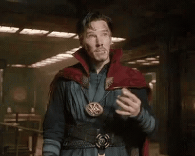 A Man In A Red Cape Is Standing In A Room With His Hands On His Chest And Says Doctor Stephen Strange . GIF