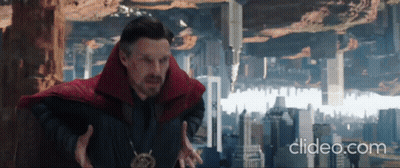 A Man In A Red Cape Is Standing In Front Of A City With The Words Clideo.com Below Him . GIF