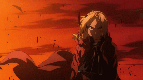 A Man In A Red Cape Is Standing In Front Of A Red And Orange Background GIF