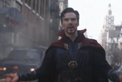 A Man In A Red Cape Stands In Front Of A Building That Says ' Tower ' On It GIF