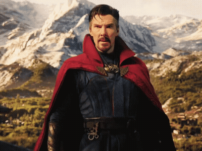 A Man In A Red Cape Stands In Front Of A Snowy Mountain GIF